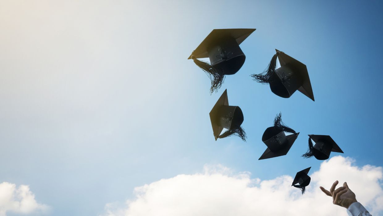 Mortar boards being thrown in the air